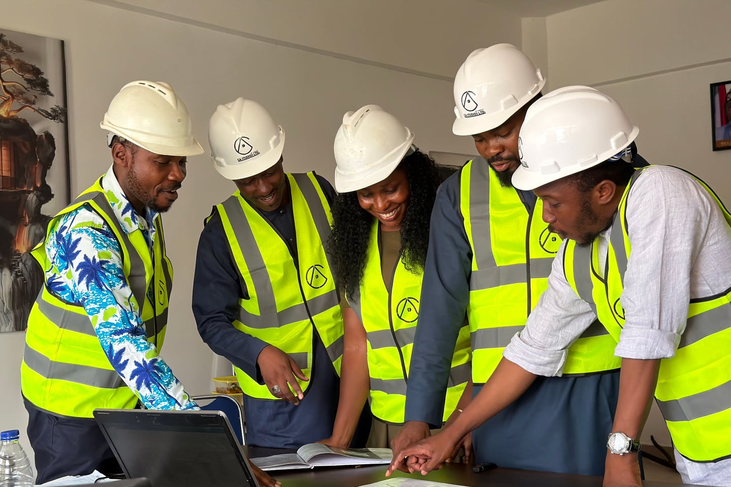 Engineers in protective equipment review construction plans.